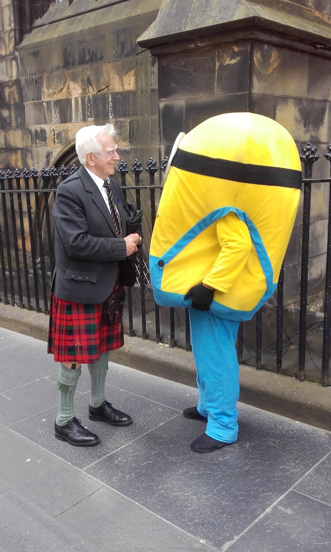 A Scottish man talking to a minion